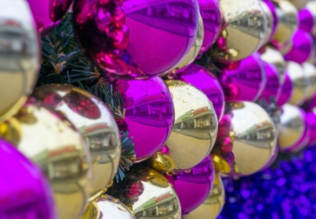 Christmas balls of gold and pink color. Festive background. Very small of depth of fieldの写真素材