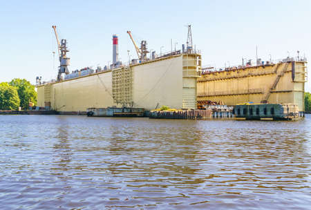 Dry dock for repair of cargo ships in port. Sunny day. Copy spaceの写真素材