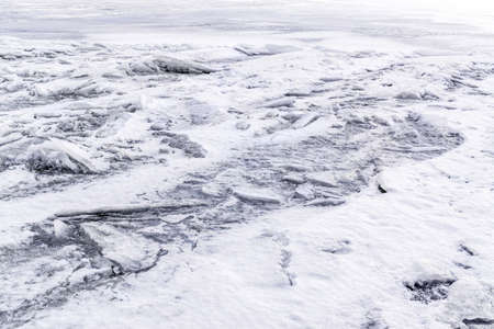 Hummocks of ice blocks on frozen river. Winter background, textureの写真素材