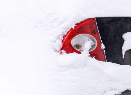 Car completely covered with snow after heavy snowfall. Only tail light is visible. Copy spaceの写真素材