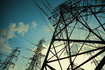 The transmission tower on blue sun sky backgroundの写真素材