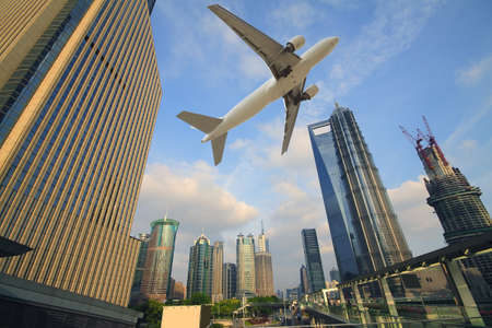 Shanghai,Aircraft is flying in the modern city buildings
の写真素材