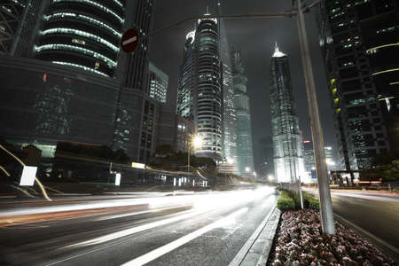 Bottom angle shooting highway car light trails of modern urban buildings 
の写真素材