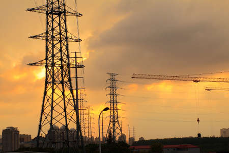 Background of the high-voltage tower in the sunsetの写真素材