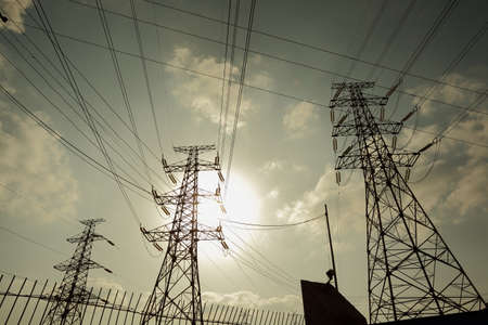 The transmission tower on blue sun sky backgroundの写真素材