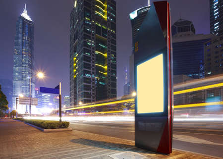 Road car light trails through at modern city advertising light boxes 
の写真素材