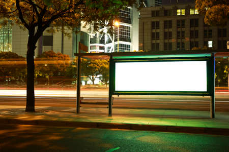 Road car light trails through at modern city advertising light boxesの写真素材