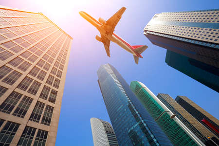 Looking up at aircraft flying over the modern urban office buildings backgrounds at Shanghai

の写真素材