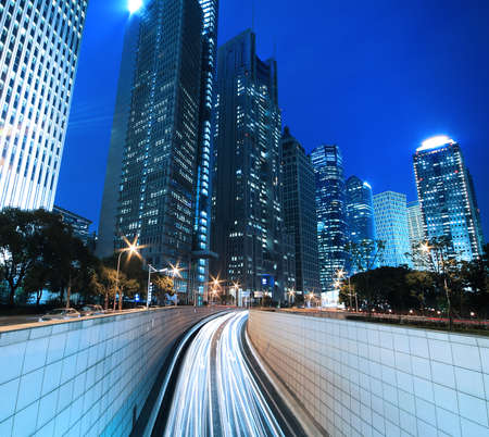 Modern landmark building background of car night with light trails in Shanghaiの写真素材