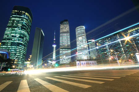 Night scene of Shanghai modern landmark buildings background car night with light trails の写真素材