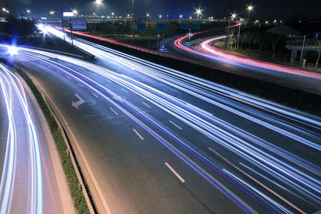 Large city road night scene, night car rainbow light trailsの写真素材