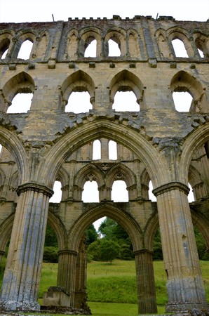 A view of the extensive ruins of the medieval Rievaulx abbey in North Yorkshireの写真素材