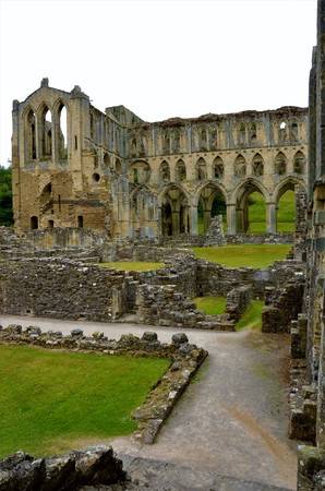 A view of the extensive ruins of the medieval Rievaulx abbey in North Yorkshireの写真素材