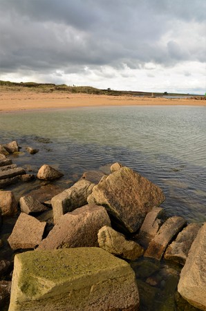 A view along the sandy and rocky seashore at Kingsbarns on the coast of Fifeの写真素材
