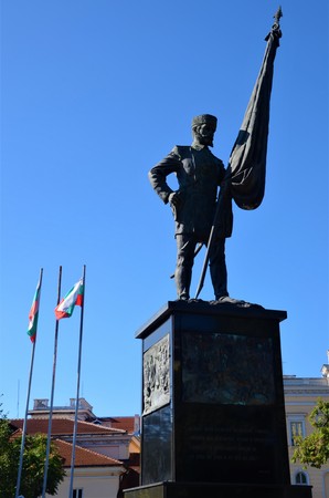 A view of a monument of a flag bearing figure with the Bulgarian flags behind, in Sofia.のeditorial素材
