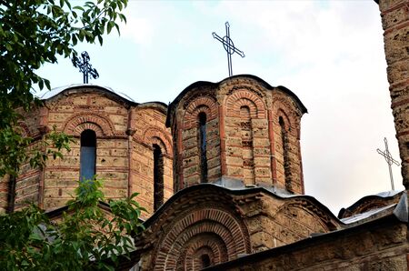 An exterior view of a derelict Orthodox church building with bell tower in the city of Prizren in...