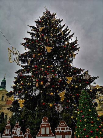A view of a giant Christmas tree with colourful baubles in the heart of Prague during the festive period.の写真素材
