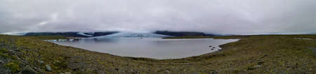 A view of floating iceberg fragments and glaciers in the glacial lagoon in southern Iceland