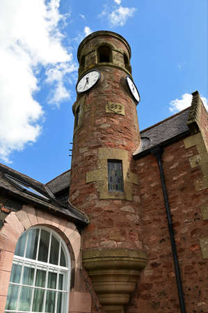 An exterior view of an old stone clock tower building in the Scottish borders village of Gordon.の写真素材