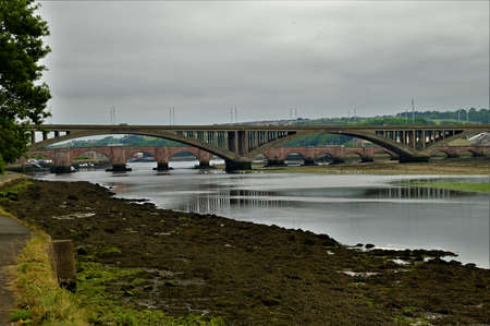 A view of the bridges which span the River Tweed in the Northumberland town of Berwick Upon Tweedの写真素材