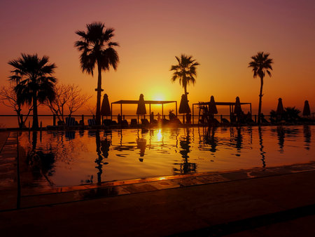 A sunset view across the swimming pool at the Dead Sea resort in the country of Jordan.の写真素材