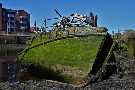 A view of old ruined boats in the old harbor at Dumbarton in Scotlandの写真素材