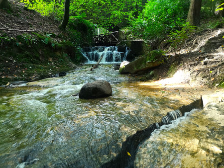A view of a small waterfall and stone bridge in the Falkland estate in Fife.の写真素材