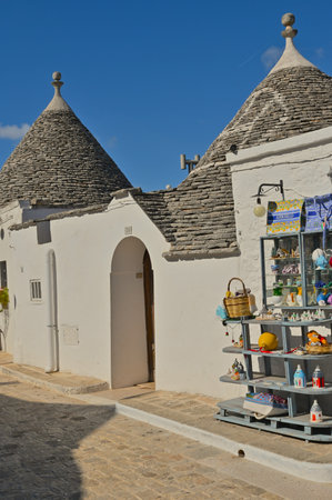 An exterior view of the historic white painted Trulli style buildings with conical roofs in the town of Alberobello in Italy.の写真素材