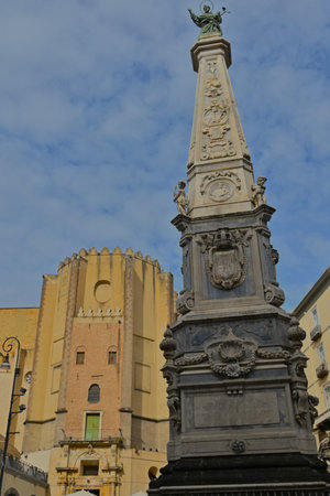 A view of an elaborately decorated stone obelisk in a piazza in the city of Naples in Italy.の写真素材