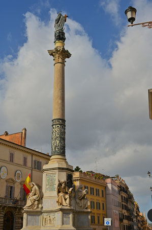 A view of an ornate monumental column in a piazza in the city of Rome in Italy.の写真素材