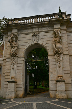 A view of the ornate entrance archway into the gardens of the Villa Celimontana in the city of Rome in Italy.の写真素材