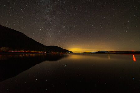 Bassenthwaite Lake in the lake district with a faint Milky Way and car lights trailing on the a66の写真素材
