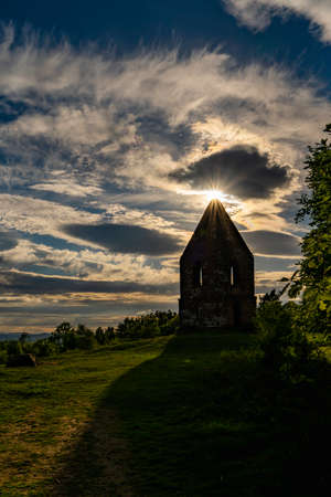 The Sun shinning through the clouds over the Penrith Beacon in the English Lake Districtの写真素材