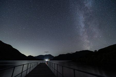 A view of the night sky over a Pier on Ullswater in the English Lake District