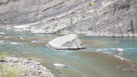 landscape of a mountain river with rocks and stones in the foregroundの写真素材