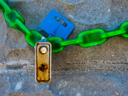 Chain with a padlock on a stone wallの写真素材