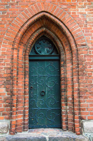 Ancient gothic door, with door handle and lockの写真素材