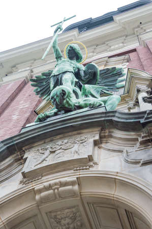 Architecture detail, angel holds a cross and beats the enemyの写真素材