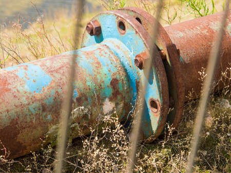 Old rusty pipe connects industrial chemical plantの写真素材