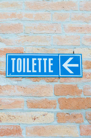 Toilet signboard with indication on a wallの写真素材