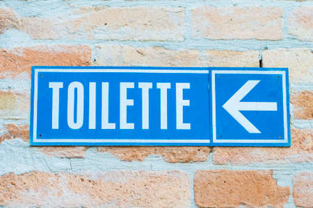 Toilet signboard with indication on a wallの写真素材