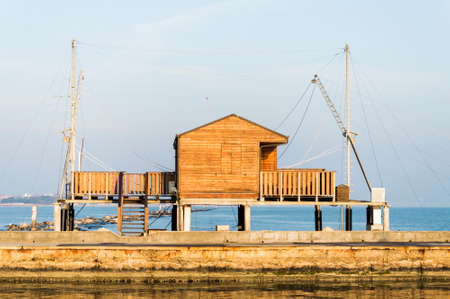 fishing hut with balance netfish Adriatic Sea in Italyのeditorial素材