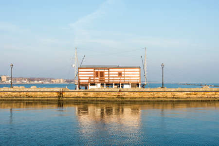 fishing hut with balance netfish Adriatic Sea in Italyのeditorial素材