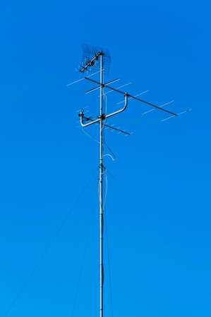Analogic television antenna in a blue sky backgroundの写真素材