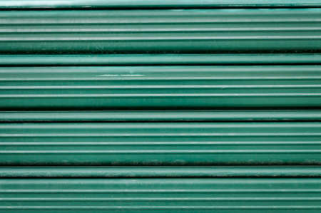 Detail of a green - iron rolling shutterの写真素材
