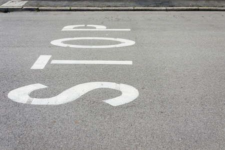 Stop word written on an asphalt roadの写真素材