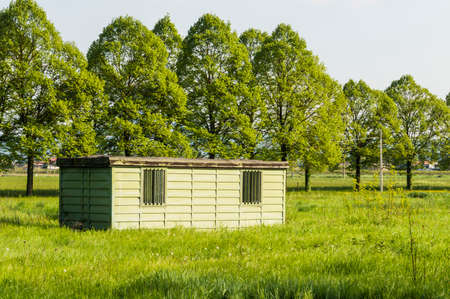 A metal hut in a green and sunny fieldの写真素材