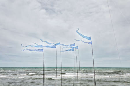 Blue waving flags near the beach Adriatic seaの写真素材