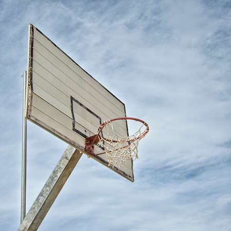 Isolated old basketball hoop with sky backgroundの写真素材