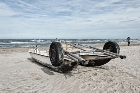 Old boat beached at the river of the seaの写真素材